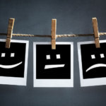 Happy sad and neutral emoticons on instant print-transfer-photographs-hanging on a clothesline